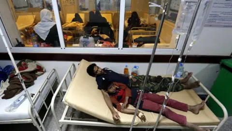 EPA Cholera-infected Yemenis receive treatment at a hospital in Sanaa, Yemen (14 June 2017)