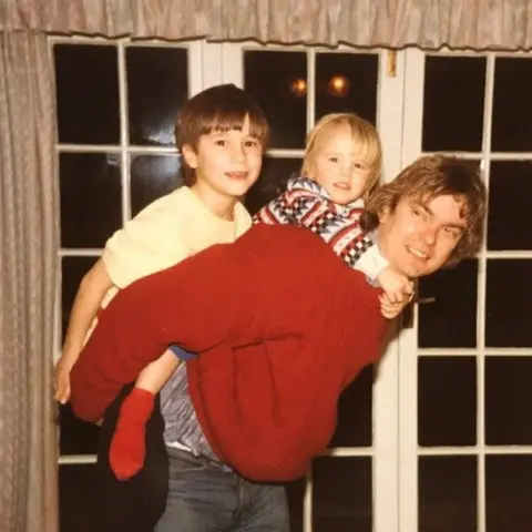 Family handout Richard with James (left) and David (centre) on his back