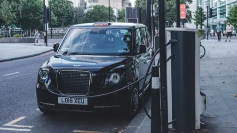 Getty Images Black cab charging at side of the road