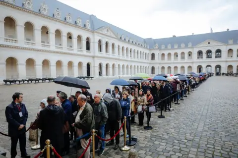 AFP People queue to say a final farewell to former French President Jacques Chirac on 29 September 2019.