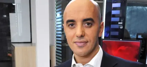 IBO/SIPA/REX/Shutterstock A head and shoulders picture of Redoine Faid in a white shirt and suit