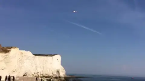 BBC A helicopter hovers over the fallen cliff at Seaford Head, East Sussex