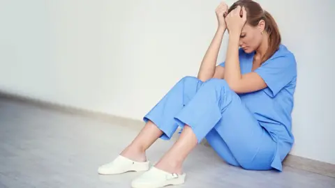Getty Images Doctor with head in hands