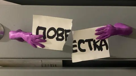 @malenkiy_piket/Instagram Plasticine hands tearing a draft notice