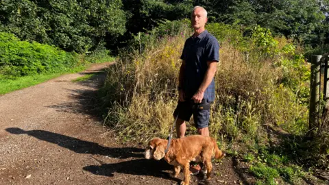 Matt Marvel/BBC Dog walker in Orwell Country park