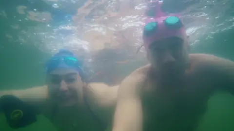 Sarah and Chris van Tulleken swimming under water