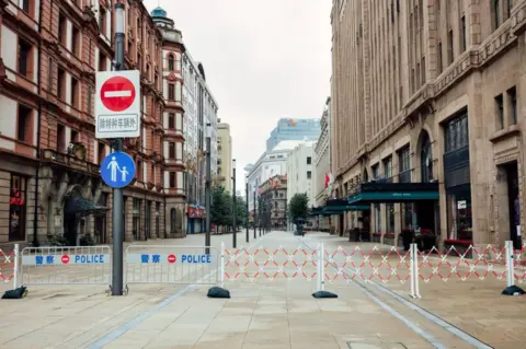 Getty Images The East Nanjing Road is blocked on May 29, 2022 in Shanghai, China. Shanghai launched a three-phase plan to restore production and life to normal.