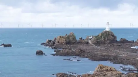 Government of Jersey A photo of Jersey's coast with an offshore windfarm