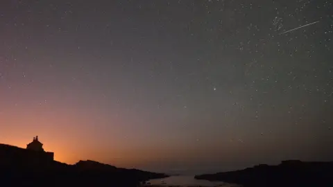 Press Association Perseid meteor shower over the Bathing House at Howick in Northumberland, August 13th 2015