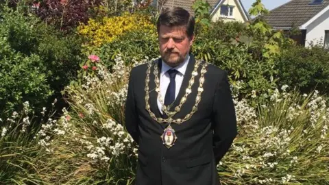 RAMSEY TOWN COMMISSIONERS Andrew Cowie observing the silence in his garden