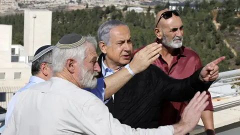 EPA Israeli Prime Minister Benjamin Netanyahu (centre) meets Israeli settler leaders in Alon Shvut settlement, in the occupied West Bank, on 19 November 2019