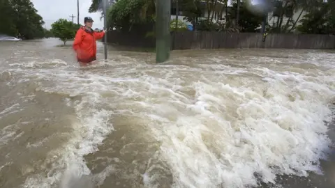 EPA Amelia Rankin in flooded waters in Hermit Park, Townsville