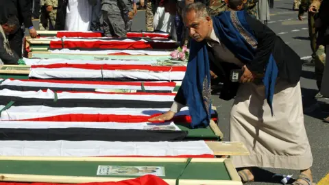 EPA Houthi supporters gather around the coffins of Houthi fighters reportedly killed in recent clashes in Sanaa, Yemen (7 December 2017)