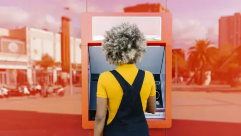 Getty Images a person at an ATM