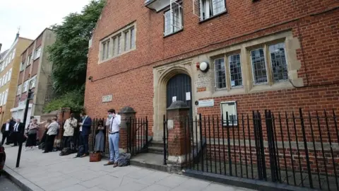 PA Media Queue of people outside Poplar Coroner's Court