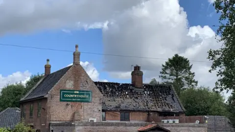 Tim Addicott/BBC View of hotel after fire