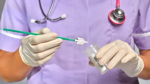 Getty Images Nurse/doctor doing a smear test