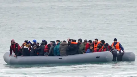 PA Media Migrants adrift in a dinghy off the coast of Folkestone, Kent on Saturday 20