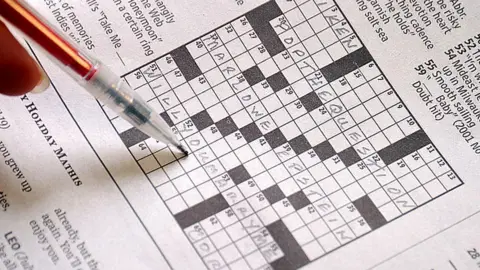 Getty Images A person filling out a crossword puzzle