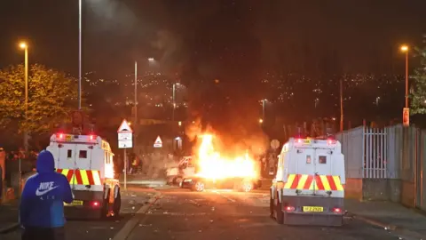 PA Police Land Rovers at the scene of the rioting in Derry