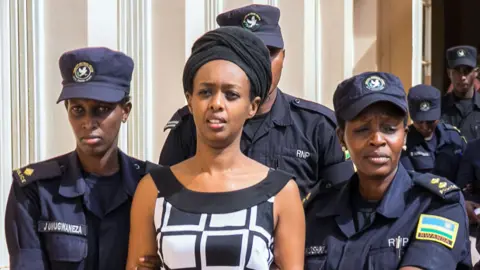 AFP Diane Rwigara (C), a prominent critic of Rwanda's President Paul Kagame, is escorted by Police officers to the court room at the Nyarugenge intermediate court in Kigali on October 9, 2017