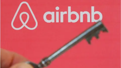 Getty Images Airbnb logo and a key