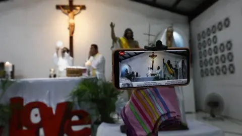 EPA A smartphone is used for online streaming of a Catholic mass to mark Easter Sunday at a church in Quezon City, Metro Manila, Philippines