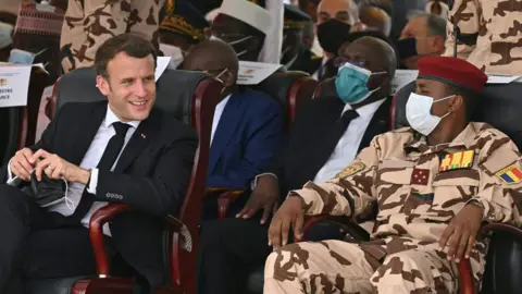 AFP French President Emmanuel Macron (L) and the son of the late Chadian president Idriss Deby, general Mahamat Idriss Deby (R), attend the state funeral for the late Chadian president Idriss Deby in N'Djamena on April 23, 2021.