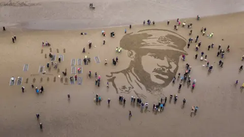 SWNS A picture of the British Army's first black officer Walter Tull is seen on Ayr Beach