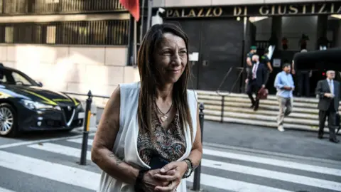 Getty Images Egle Possetti, president of the committee representing the families of the 43 victims, talks to journalists outside the Genoa courthouse