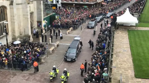 Haskan Kaya Aerial view of hearse arriving at Great St Mary's Church in Cambridge