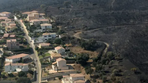 AFP An aerial view taken on July 25, 2017 shows the fire devastated landscape in Biguglia, on the French Mediterranean island of Corsica.
