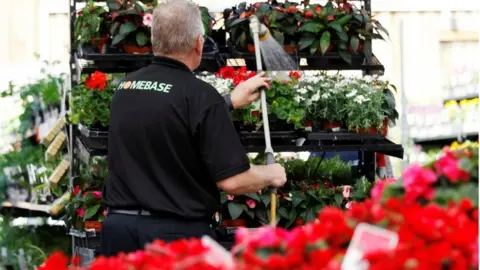 Reuters Homebase worker watering flowers