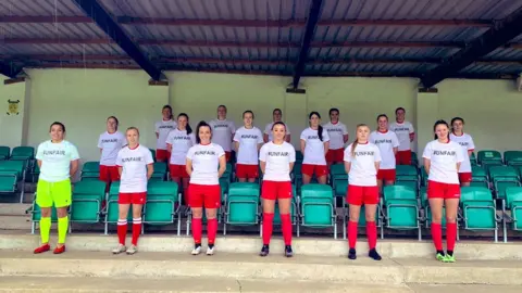 Abergavenny Women's FC Players at Abergavenny wearing T-shirts bearing the word "unfair"