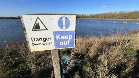 Shaun Whitmore/BBC A sign warning people about the water nearby