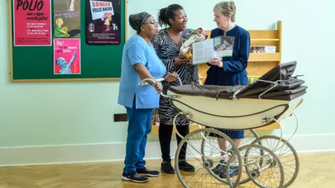 Nick Robinson Two people with a midwife