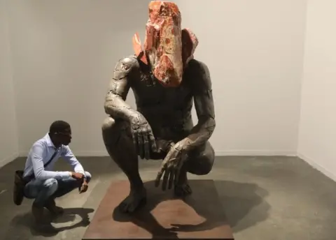 EPA An art lover looks at a sculpture during the annual Joburg Art Fair held at the Sandton Convention centre, Johannesburg, South Africa, 07 September 2018.