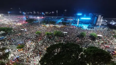 Getty Images A general view of the crowd ahead of Madonna's performance at Copacabana beach