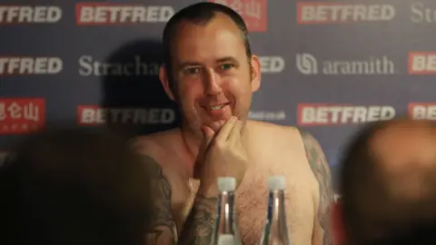Getty Images Mark Williams attends press conference naked after winning the world snooker title in 2018