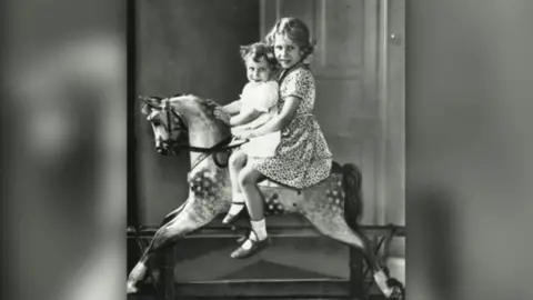 Topfoto Princesses Elizabeth and Margaret on a rocking horse in the nursery in taken 1932.