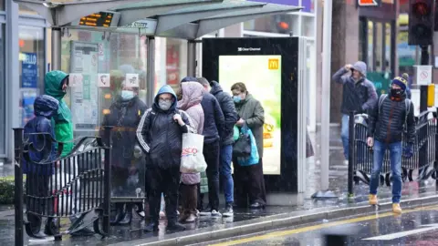 PA Media Rain lashed down on commuters in Glasgow