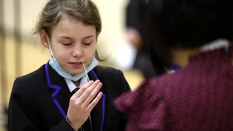 A student takes a Covid-19 lateral flow test, 4 January 2021