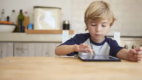 Getty Images Young boy using a tablet