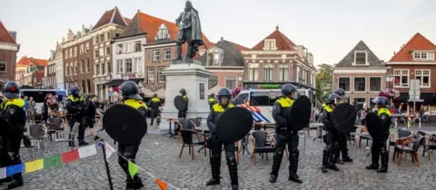 AFP Police stands guard around the statue of Jan Pieterszoon Coen in Hoorn, on June 19, 2020