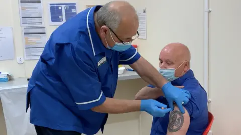 BBC James Redmond receiving a Covid-19 vaccine