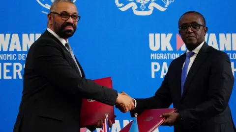 Reuters British Home Secretary James Cleverly and Rwandan Minister of Foreign Affairs Vincent Biruta sign a new treaty, in Kigali, Rwanda, December 5, 2023