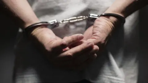 Getty Images Man in handcuffs