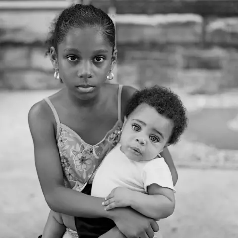 Lucas Foglia Shalena Laiz holding her cousin Glenroy Bennett