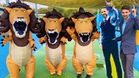 Howard Junior School School teacher with Gareth Southgate cut-out and inflatable lions