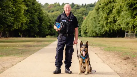 Thin Blue Paw Foundation/Penny Bi PC Ian Sweeney with retired police dog Logan